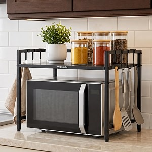 amazon basics height adjustable microwave oven stand for kitchen counter  single layer heavy duty metal microwave amp otg rack with 8 hooks  kitchen organizer shelf for oven utensils amp appliances  black