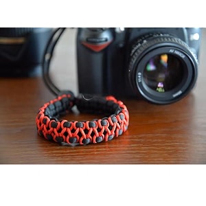 rubric braided herringbone paracord hand grip wrist strap for all dslr camerabinoculars black and orange hb
